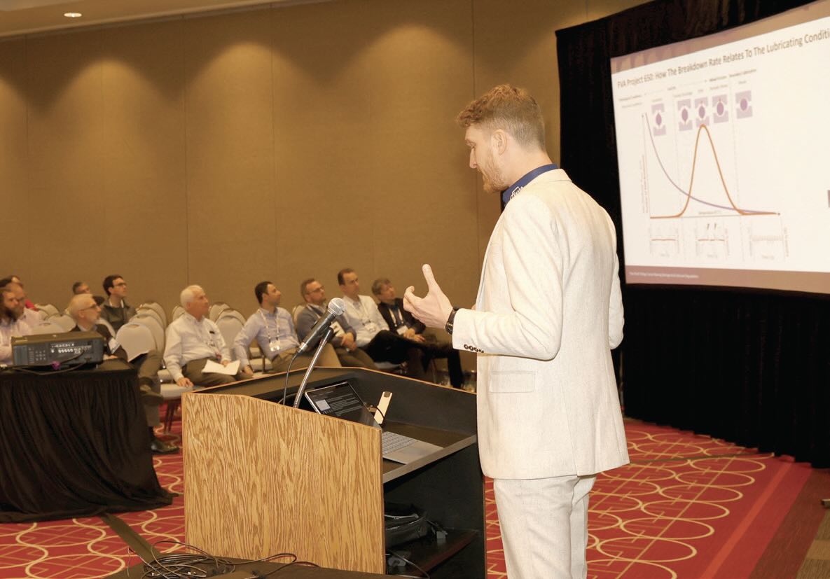 A man presents during a technical session at an STLE conference.