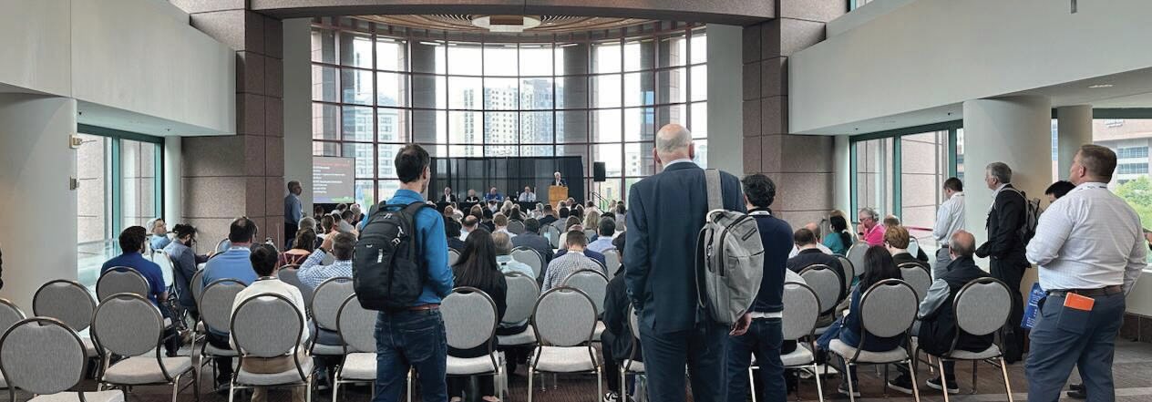 A photo of a panel discussion taken from the back of the audience.