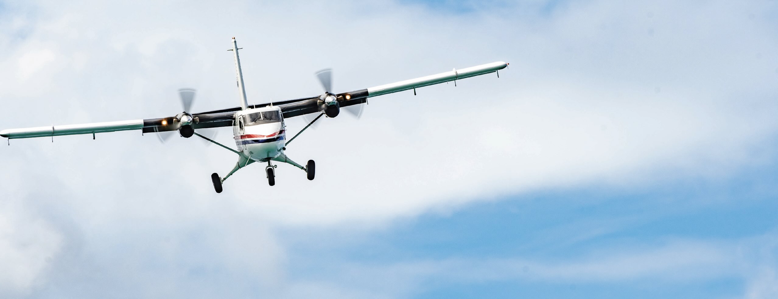 A front view of a small airplane in flight.